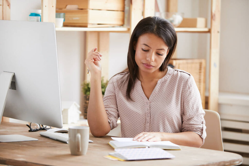 Woman Thinking While Writing